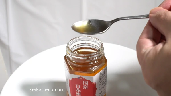 回転してはちみつを切ったステンレススプーン