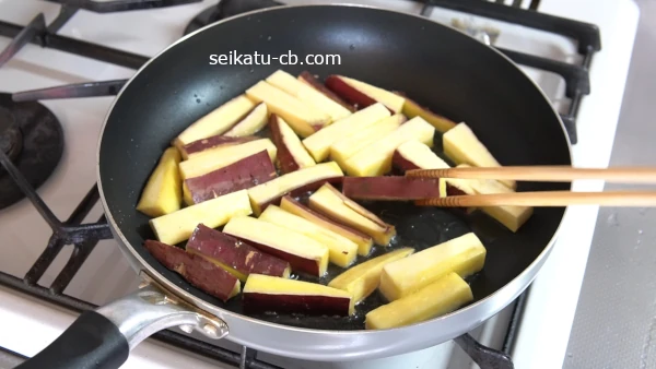 さつまいもスティックの焼けた面を返す